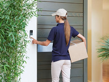 Postbotin betätigt die smarte Videotürklingel von Netatmo Postbotin betätigt die smarte Videotürklingel von Netatmo